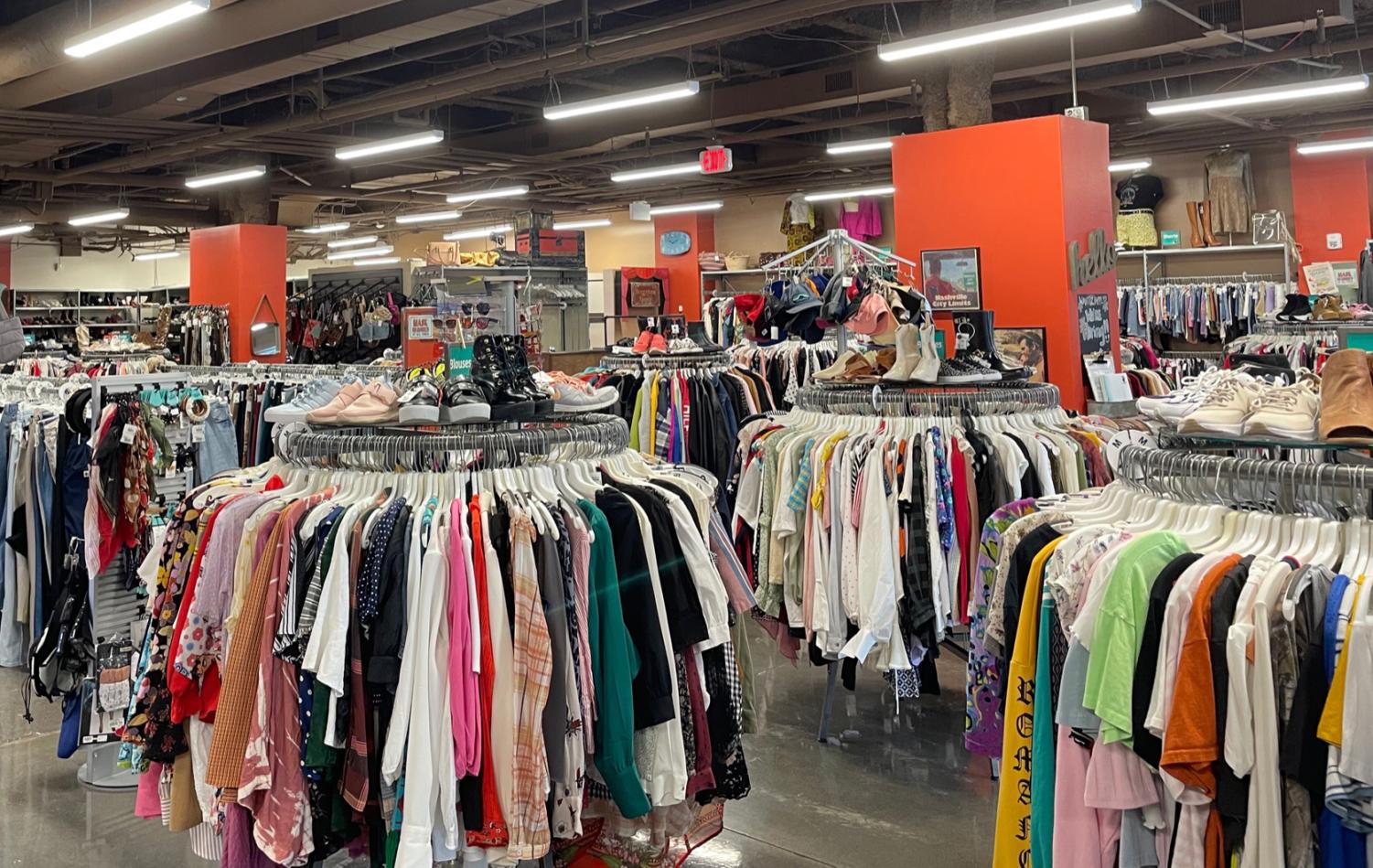 Inside a thrift store - clothes, shoes and jackets lined up, part of the recycling trend and sustainable fashion