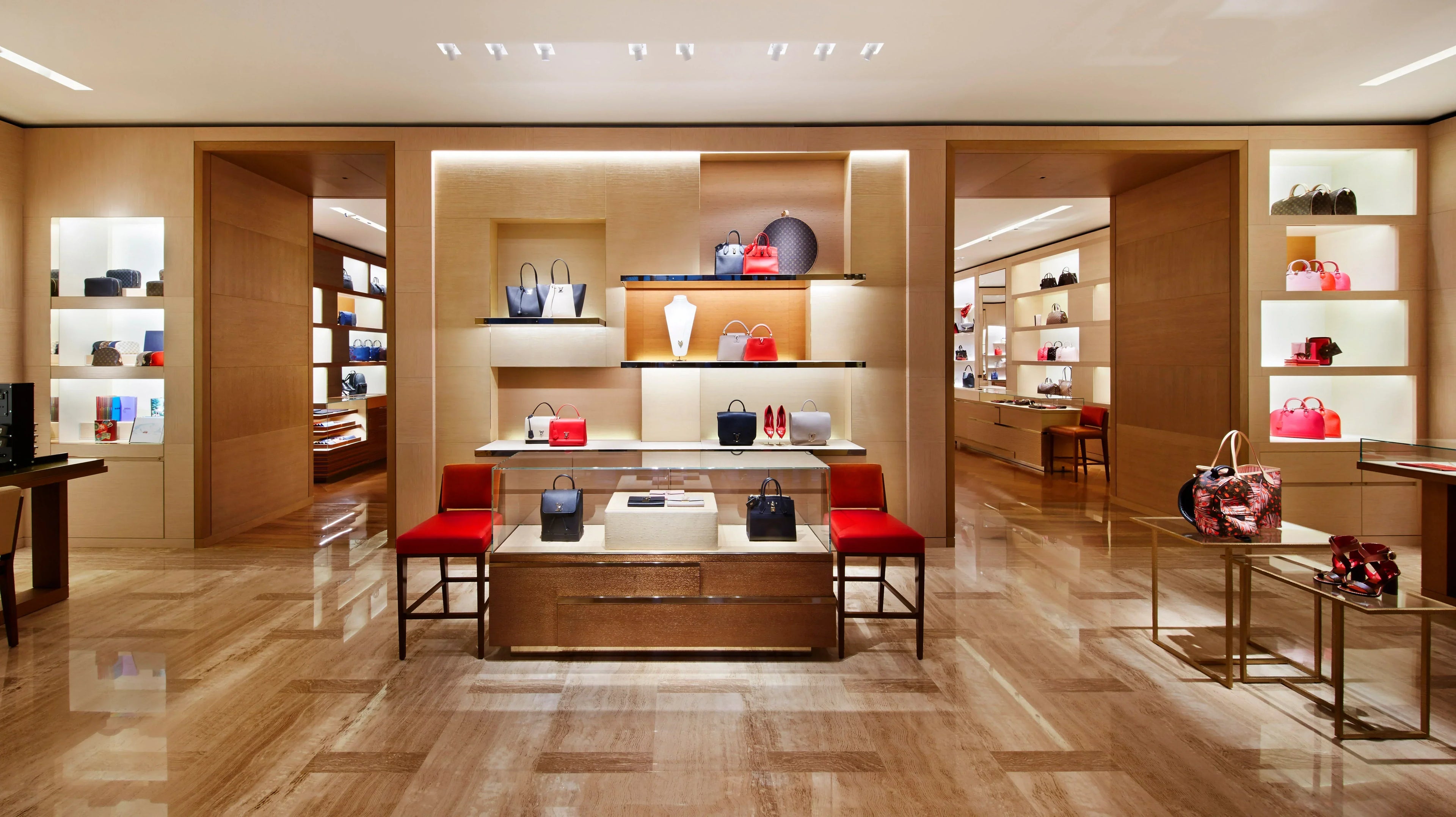Interior of a luxury bag store with designer handbags displayed on shelves